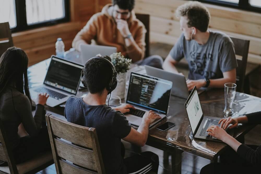 Team members collaborating at a table on a project